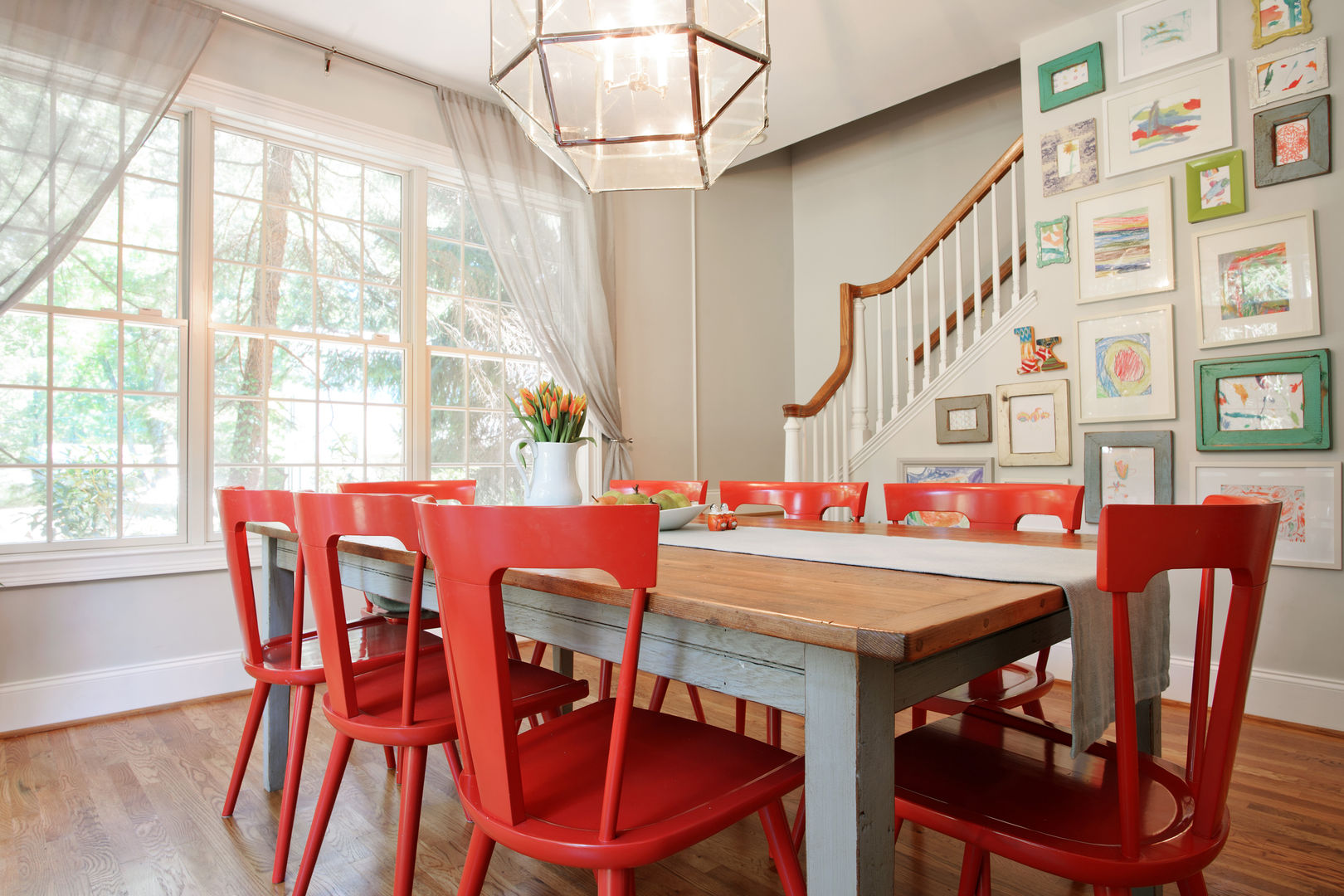 Modern Farmhouse Dining Room Larina Kase Interior Design Modern Dining Room Solid Wood Multicolored reclaimed wood table,farmhouse table,red chairs,red dining chairs,eclectic dining space